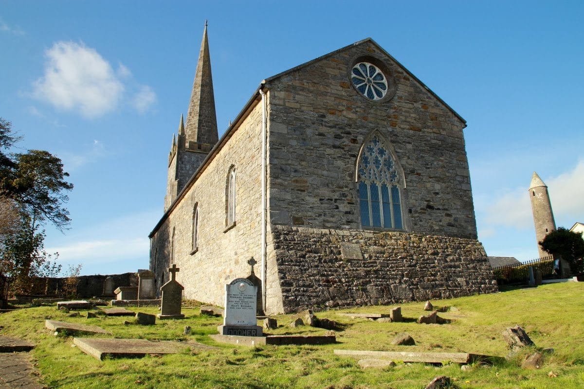 . A view of Killala’s 17th century cathedral with the 12th century round tower to the right and the souterrain entrance in the foreground.